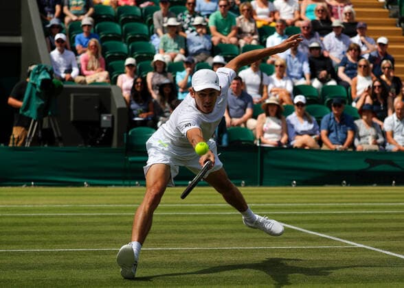 4th July 2022, All England Lawn Tennis and Croquet Club, London, England; Wimbledon Tennis tournament; Alexde Minaur (AUS) plays a backhand to Cristian Garin (CHL)  ActionPlus12405045 JohnxPatrickxFletcher