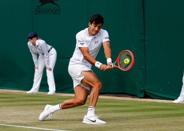 4th July 2022, All England Lawn Tennis and Croquet Club, London, England; Wimbledon Tennis tournament; Cristian Garin (CHL) plays a backhand to Alexde Minaur (AUS)  ActionPlus12405047 JohnxPatrickxFletcher