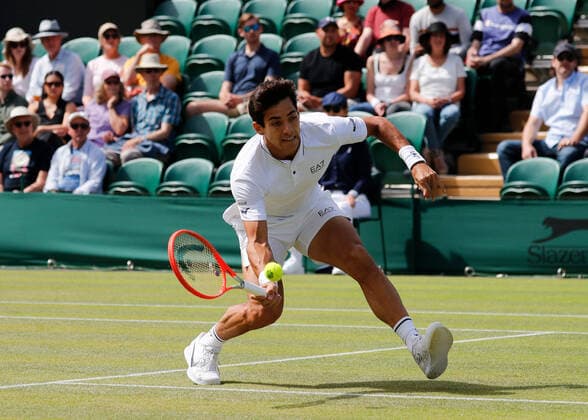 4th July 2022, All England Lawn Tennis and Croquet Club, London, England; Wimbledon Tennis tournament; Cristian Garin (CHL) plays a forehand to Alexde Minaur (AUS)  ActionPlus12405053 JohnxPatrickxFletcher