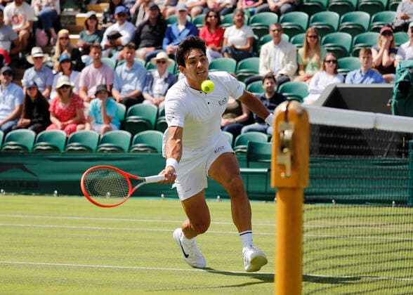 4th July 2022, All England Lawn Tennis and Croquet Club, London, England; Wimbledon Tennis tournament; Cristian Garin (CHL) plays a forehand to Alexde Minaur (AUS)  ActionPlus12405064 JohnxPatrickxFletcher
