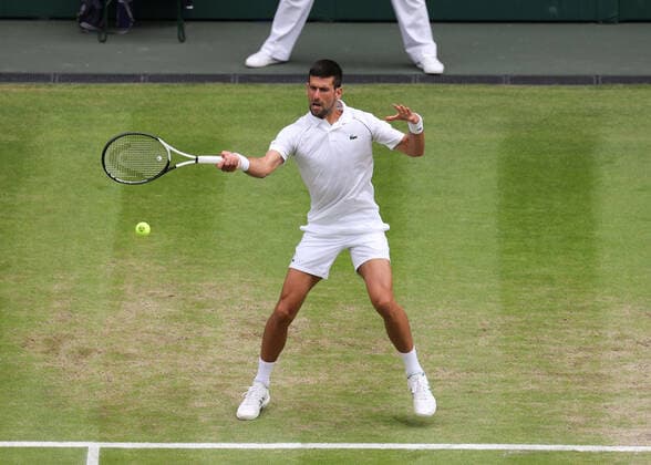 5th July 2022, All England Lawn Tennis and Croquet Club, London, England; Wimbledon Tennis tournament; Novak Djokovic (SRB) plays a forehand to Jannik Sinner (ITA) mens singles quarter-final  ActionPlus12405242 JohnxPatrickxFletcher