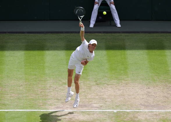 5th July 2022, All England Lawn Tennis and Croquet Club, London, England; Wimbledon Tennis tournament; Jannik Sinner (ITA) serves to Novak Djokovic (SRB) mens singles quarter-final  ActionPlus12405255 JohnxPatrickxFletcher