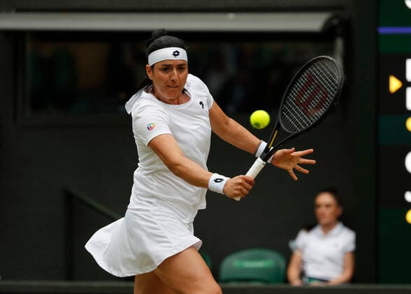 5th July 2022, All England Lawn Tennis and Croquet Club, London, England; Wimbledon Tennis tournament; Ons Jabeur (TUN) plays a backhand to Marie Bouzkova (CZE)  ActionPlus12405328 JohnxPatrickxFletcher