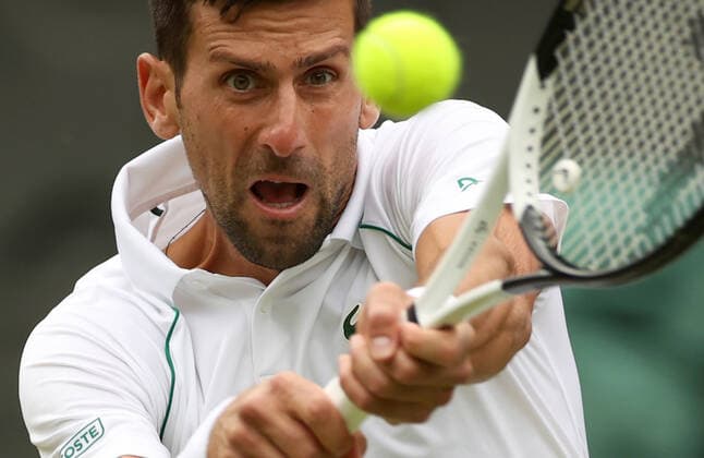 (220706) -- LONDON, July 6, 2022 -- Novak Djokovic of Serbia hits a return during the men s singles quarter-final match against Jannik Sinner of Italy at Wimbledon Tennis Championship in London, Britain, on July 5, 2022. ) (SP)BRITAIN-LONDON-TENNIS-WIMBLEDON-MEN S SINGLES-QUARTERFINALS LixYing 