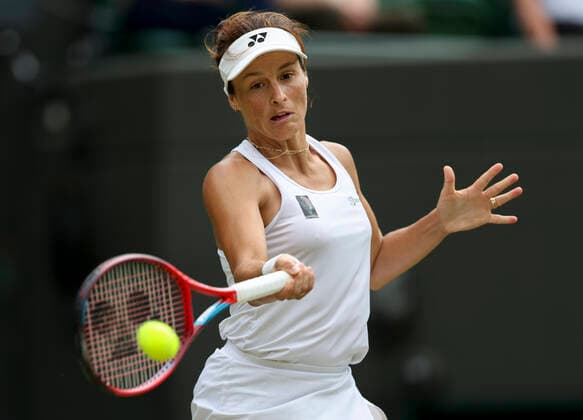 (220706) -- LONDON, July 6, 2022 -- Tatjana Maria of Germany hits a return during the women s singles quarter-final match against her compatriot Jule Niemeier at Wimbledon Tennis Championship in London, Britain, on July 5, 2022. ) (SP)BRITAIN-LONDON-TENNIS-WIMBLEDON-WOMEN S SINGLES-QUARTERFINALS HanxYan 