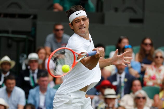 6th July 2022, All England Lawn Tennis and Croquet Club, London, England; Wimbledon Tennis tournament; Taylor Fritz (USA) plays a forehand to Rafael Nadal (ESP)  ActionPlus12405462 JohnxPatrickxFletcher