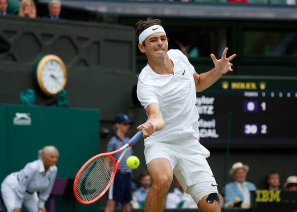 6th July 2022, All England Lawn Tennis and Croquet Club, London, England; Wimbledon Tennis tournament; Taylor Fritz (USA) plays a forehand to Rafael Nadal (ESP)  ActionPlus12405473 JohnxPatrickxFletcher