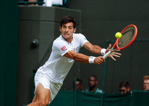 6th July 2022, All England Lawn Tennis and Croquet Club, London, England; Wimbledon Tennis tournament; Cristian Garin (CHI) plays a backhand to Nick Kyrgios (AUS)  ActionPlus12405494 JohnxPatrickxFletcher