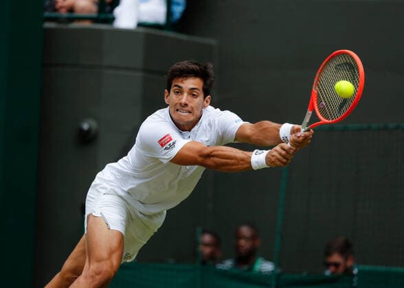 6th July 2022, All England Lawn Tennis and Croquet Club, London, England; Wimbledon Tennis tournament; Cristian Garin (CHI) plays a backhand to Nick Kyrgios (AUS)  ActionPlus12405497 JohnxPatrickxFletcher