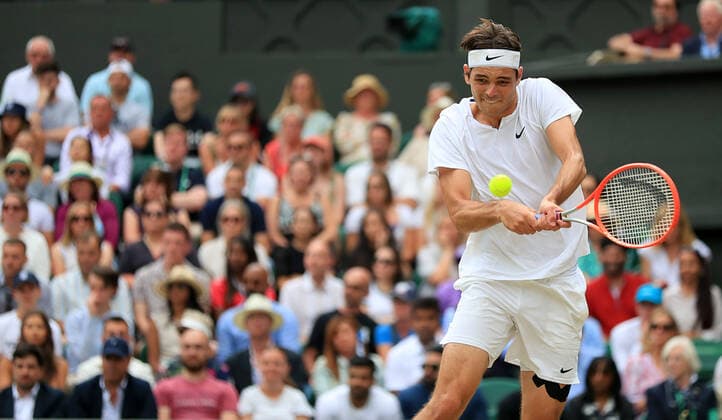 (220707) -- LONDON, July 7, 2022 -- Taylor Fritz of the United States hits a return during the men s singles quarter-final match against Rafael Nadal of Spain at Wimbledon Tennis Championship in London, Britain, on July 6, 2022. ) (SP)BRITAIN-LONDON-TENNIS-WIMBLEDON-MEN S SINGLES-QUARTERFINALS LixYing 