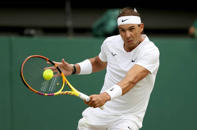 (220707) -- LONDON, July 7, 2022 -- Rafael Nadal of Spain hits a return during the men s singles quarter-final match against Taylor Fritz of the United States at Wimbledon Tennis Championship in London, Britain, on July 6, 2022. ) (SP)BRITAIN-LONDON-TENNIS-WIMBLEDON-MEN S SINGLES-QUARTERFINALS LixYing 