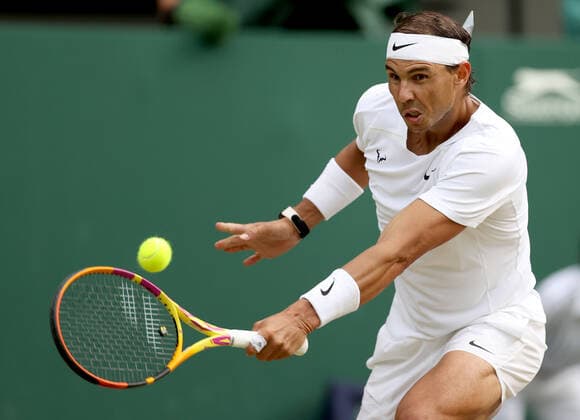 (220707) -- LONDON, July 7, 2022 -- Rafael Nadal of Spain hits a return during the men s singles quarter-final match against Taylor Fritz of the United States at Wimbledon Tennis Championship in London, Britain, on July 6, 2022. ) (SP)BRITAIN-LONDON-TENNIS-WIMBLEDON-MEN S SINGLES-QUARTERFINALS LixYing 