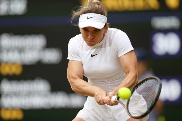 (220707) -- LONDON, July 7, 2022 -- Simona Halep of Romania hits a return during the women s singles quarter-final match against Amanda Anisimova of the United States at Wimbledon Tennis Championship in London, Britain, on July 6, 2022. ) (SP)BRITAIN-LONDON-TENNIS-WIMBLEDON-WOMEN S SINGLES-QUARTERFINALS LixYing 