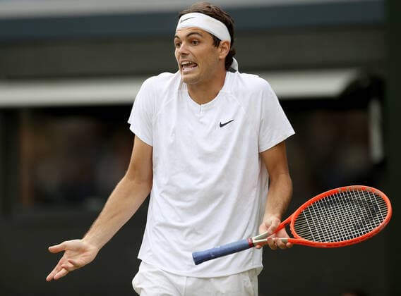 (220707) -- LONDON, July 7, 2022 -- Taylor Fritz of the United States reacts during the men s singles quarter-final match against Rafael Nadal of Spain at Wimbledon Tennis Championship in London, Britain, on July 6, 2022. ) (SP)BRITAIN-LONDON-TENNIS-WIMBLEDON-MEN S SINGLES-QUARTERFINALS LixYing 