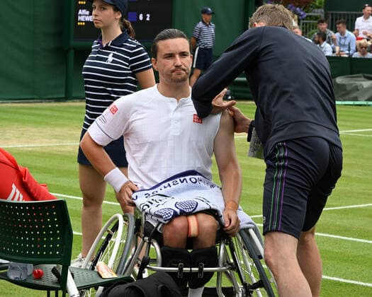 Tennis Championships - Week One - Day Eleven - All England Lawn Tennis Club, Wimbledon - Thursday 7th July 2022 Mens Wheelchair Singles. Gordon Reid (GBR) v Alfie Hewett (GBR) Gordon Reid receives attention for an arm injury 