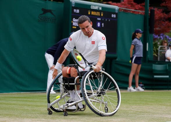 7th July 2022, All England Lawn Tennis and Croquet Club, London, England; Wimbledon Tennis tournament; Gordon Reid (GBR) plays a backhand to Alfie Hewett (GBR) in mens wheelchair quarter-final match  ActionPlus12405638 JohnxPatrickxFletcher
