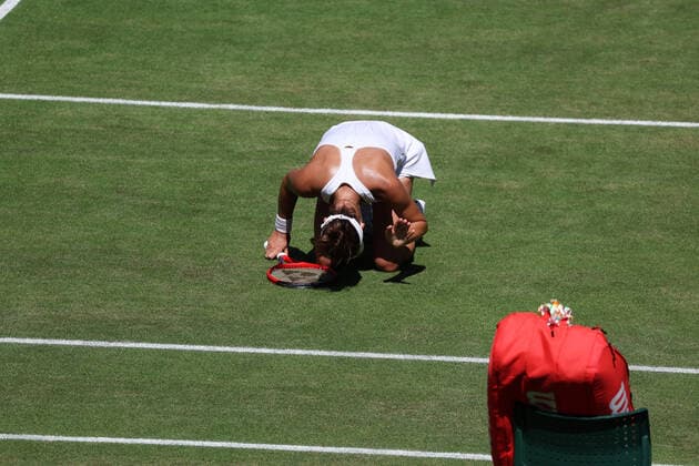 7th July 2022, All England Lawn Tennis and Croquet Club, London, England; Wimbledon Tennis tournament; Tatjana Maria (GER) on her knees in disappointment after her forehand shot hits the net to give Ons Jabeur (TUN) a vital game point  ActionPlus12405686 JohnxPatrickxFletcher