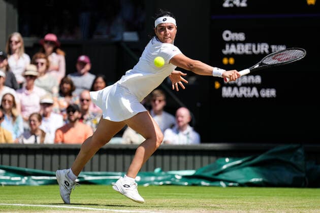 (220708) -- LONDON, July 8, 2022 -- Ons Jabeur of Tunisia hits a return during the women s singles semifinal match against Tatjana Maria of Germany at Wimbledon Tennis Championship in London, Britain, on July 7, 2022. (Photo by Xinhua) (SP)BRITAIN-LONDON-TENNIS-WIMBLEDON-WOMEN S SINGLES-SEMIFINALS ShixTang 
