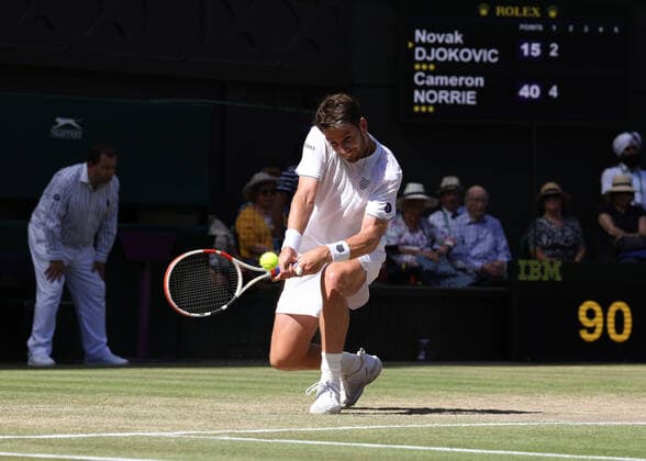 8th July 2022, All England Lawn Tennis and Croquet Club, London, England; Wimbledon Tennis tournament; Cameron Norrie (GBR) plays a backhand to Novak& xa0;Djokovic (SRB) in the mens singles semi-final match  ActionPlus12406047 JohnxPatrickxFletcher