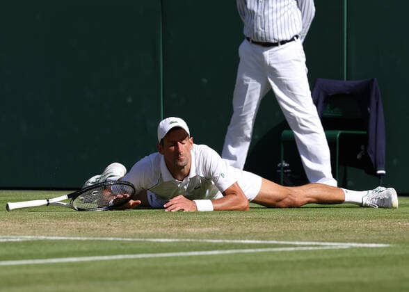 8th July 2022, All England Lawn Tennis and Croquet Club, London, England; Wimbledon Tennis tournament; Novak& xa0;Djokovic (SRB) slips and falls on court in the mens singles semi-final match  ActionPlus12406082 JohnxPatrickxFletcher