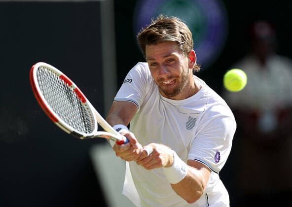 (220709) -- LONDON, July 9, 2022 -- Cameron Norrie of Great Britain hits a return during the men s singles semifinal match against Novak Djokovic of Serbia at Wimbledon Tennis Championship in London, Britain, on July 8, 2022. ) (SP)BRITAIN-LONDON-TENNIS-WIMBLEDON-MEN S SINGLES-SEMIFINALS LixYing 