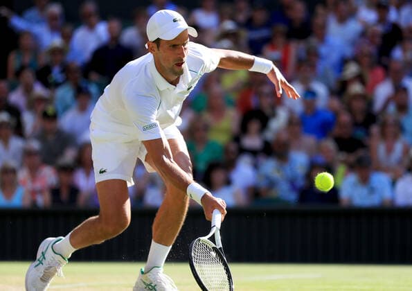 (220709) -- LONDON, July 9, 2022 -- Novak Djokovic of Serbia hits a return during the men s singles semifinal match against Cameron Norrie of Great Britain at Wimbledon Tennis Championship in London, Britain, on July 8, 2022. ) (SP)BRITAIN-LONDON-TENNIS-WIMBLEDON-MEN S SINGLES-SEMIFINALS LixYing 