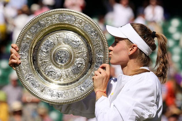9th July 2022, All England Lawn Tennis and Croquet Club, London, England; Wimbledon Tennis tournament, womens singles final; Elena Rybakina (KAZ) kisses the Wimbledon Ladies Trophy  ActionPlus12406692 JohnxPatrickxFletcher