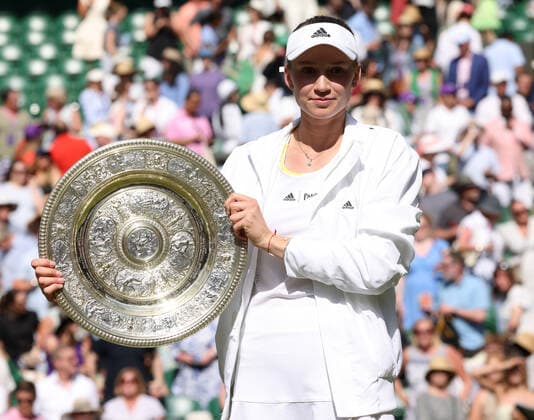 Kazakhstan s Elena Rybakina holds the trophy in victory in her Women s Final match against Tunisian Ons Jabeur at the 2022 Wimbledon championships in London on Saturday, July 9, 2022. Rybakina won the match 3-6,6-2,6-2.  LON2022070902 HUGOxPHILPOTT