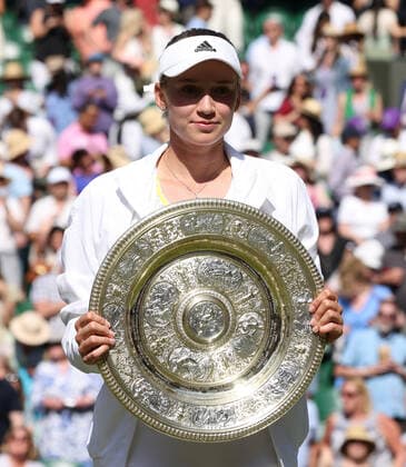 Kazakhstan s Elena Rybakina holds the trophy in victory in her Women s Final match against Tunisian Ons Jabeur at the 2022 Wimbledon championships in London on Saturday, July 9, 2022. Rybakina won the match 3-6,6-2,6-2.  LON202207090333 HUGOxPHILPOTT