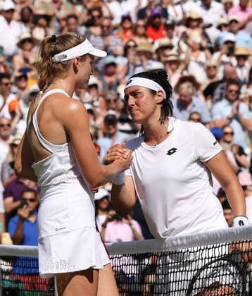 Kazakhstan s Elena Rybakina (L) consoles her opponent Tunisian Ons Jabeur in the Women s Final match on day thirteen of the 2022 Wimbledon championships in London on Saturday, July 9, 2022. Rybakina won the match 3-6,6-2,6-2.  LON2022070906 HUGOxPHILPOTT