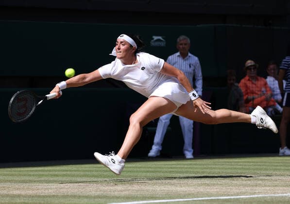 Tunisian Ons Jabeur stretches for a ball in her Women s Final match against Kazakhstan s Elena Rybakina on day thirteen of the 2022 Wimbledon championships in London on Saturday, July 09, 2022. Rybakina won the match 3-6,6-2,6-2.  LON2022070909 HUGOxPHILPOTT