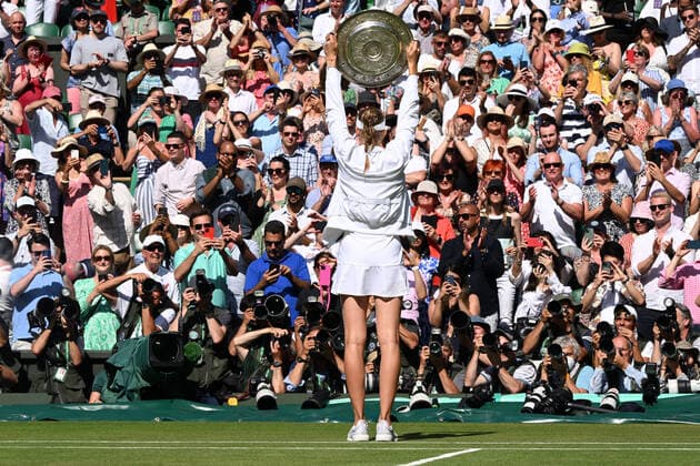 Tennis Championships - Week Two - Day Thirteen - All England Lawn Tennis Club, Wimbledon - Saturday 9th July 2022 Ladies Singles Final. Elena Rybakina (KAZ) v Ons Jabeur (TUN) Elena Rybakina (KAZ) raises the Winners plate to the crowd and Photographers 