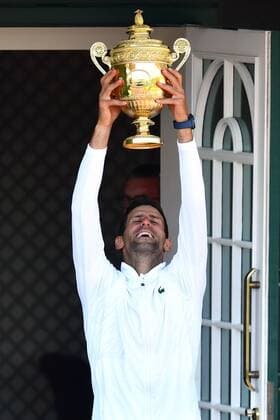Mandatory Credit: Photo by James Veysey Shutterstock (13018061bf) Novak Djokovic appears on the Centre Court Members balcony after victory in the Men s Singles Final Wimbledon Tennis Championships, Day 14, The All England Lawn Tennis and Croquet Club, London, UK - 10 Jul 2022 Wimbledon Tennis Championships, Day 14, The All England Lawn Tennis and Croquet Club, London, UK - 10 Jul 2022  Copyright: xJamesxVeysey Shutterstockx 13018061bf