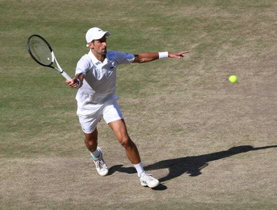 Serbian Novak Djokovic plays a forehand in the Men s Final match against Australian Nick Kyrgios on day fourteen of the 2022 Wimbledon championships in London on Sunday, July 10, 2022. Djokovic won the match 4-6,6-3,6-4,7-6.  LON2022071001 HUGOxPHILPOTT