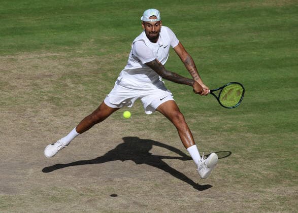 Australian Nick Kyrgios plays a backhand in the Men s Final match against Serbian Novak Djokovic on day fourteen of the 2022 Wimbledon championships in London on Sunday, July 10, 2022. Djokovic won the match 4-6,6-3,6-4,7-6.  LON2022071008 HUGOxPHILPOTT