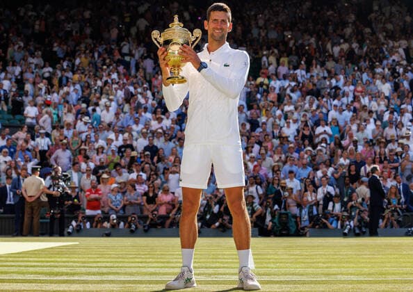 Serbian Novak Djokovic holds the Wimbledon trophy after victory in the Men s Final match against Australian Nick Kyrgios on day fourteen of the 2022 Wimbledon championships in London on Sunday, July 10, 2022. Djokovic won the match 4-6,6-3,6-4,7-6.  LON2022071022 HUGOxPHILPOTT
