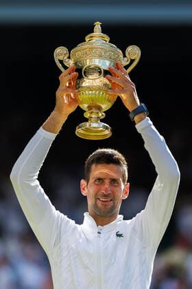 Serbian Novak Djokovic holds the Wimbledon trophy after victory in the Men s Final match against Australian Nick Kyrgios on day fourteen of the 2022 Wimbledon championships in London on Sunday, July 10, 2022. Djokovic won the match 4-6,6-3,6-4,7-6.  LON2022071024 HUGOxPHILPOTT