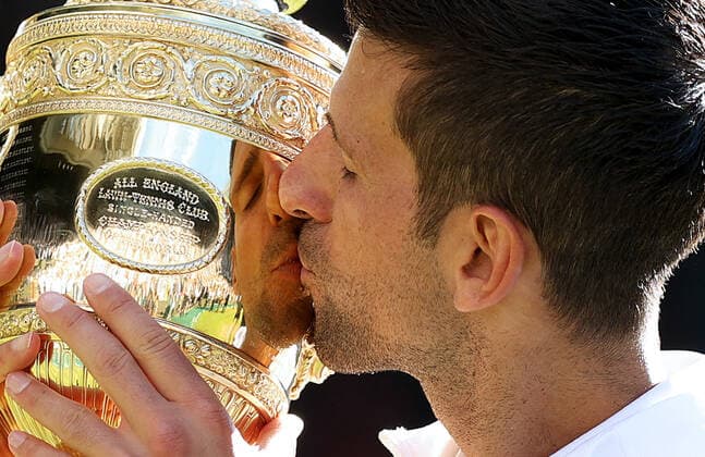 (220711) -- LONDON, July 11, 2022 -- Novak Djokovic kisses his trophy after winning the men s singles final match between Novak Djokovic of Serbia and Nick Kyrgios of Australia at Wimbledon Tennis Championship in London, Britain, on July 10, 2022. ) (SP)BRITAIN-LONDON-TENNIS-WIMBLEDON-MEN S SINGLES-FINAL LixYing 