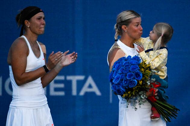 Czech tennis players Lucie Hradecka, left, and Andrea Sestini Hlavackova, right (with her daughter), are seen during the Livesport Prague Open WTA, Tennis Damen women’s tennis tournament, doubles, quarterfinal, against Miyu Kato and Samantha Murray, the last match in Hlavackova s professional career, on July 28, 2022, in Prague, Czech Republic. (CTKxPhoto OndrejxDeml) CTKPhotoP2022072808513