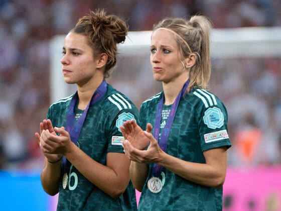 Lena Sophie Oberdorf 6 Germany and Kathrin Hendrich 3 Germany watch sadly as England is presented with the European Championship trophy Wembley Wembley Stadium London England