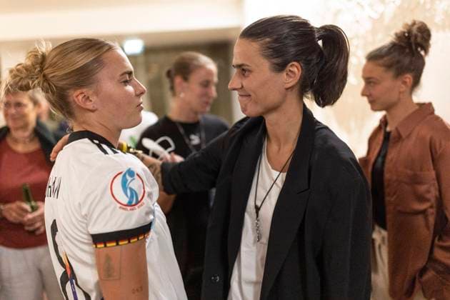 Banquet For The Germany Women s National Team LONDON, ENGLAND JULY 31 Laura Freigang of Germany speaks with Dzsenifer Marozsan during a banquet for the Germany Women s National Team following the loss of the UEFA Women s EURO 2022 final match against England on July 31, 2022 in London, England Photo by Maja Hitij Getty Images for DFB London England United Kingdom Poolfoto Getty Images for DFB ,EDITORIAL USE ONLY
