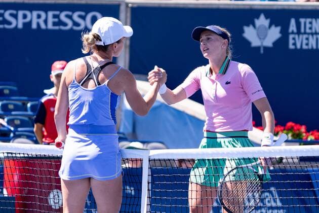 TORONTO, ON - AUGUST 11: Jil Teichmann and Simona Halep shake hands after their National Bank Open tennis tournament third round match on August 11, 2022, at Sobeys Stadium in Toronto, ON, Canada. (Photo by Julian Avram Icon Sportswire) TENNIS: AUG 11 National Bank Open Icon2208111466