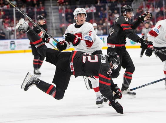 August 17, 2022, EDMONTON, AB, CANADA: Canada s Jack Thompson (22) is checked by Switzerland s Giancarlo Chanton (5) during first period IIHF World Junior Hockey Championship quarterfinal action in Edmonton on Wednesday August 17, 2022. Canada News - August 17, 2022  - ZUMAc35_ 20220817_zaf_c35_101 Copyright: xJasonxFransonx