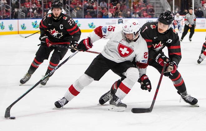August 17, 2022, EDMONTON, AB, CANADA: Canada s Donovan Sebrango (7) and Switzerland s Jonas Taibel (25) battle for the puck during first period IIHF World Junior Hockey Championship quarterfinal action in Edmonton on Wednesday August 17, 2022. Canada News - August 17, 2022  - ZUMAc35_ 20220817_zaf_c35_102 Copyright: xJasonxFransonx