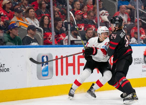 August 17, 2022, Edmonton, Alberta, Canada: ETHAN DEL MASTERO (24) of Canada body checks ATTILIO BIASCA (17) of Switzerland during the first period of a 2022 IIHF World Junior Championship quarter-final playoff match at Rogers Place in Edmonton, Alberta. Edmonton Canada - ZUMAh176 20220817_zsp_h176_079 Copyright: xMatthewxHelfrichx