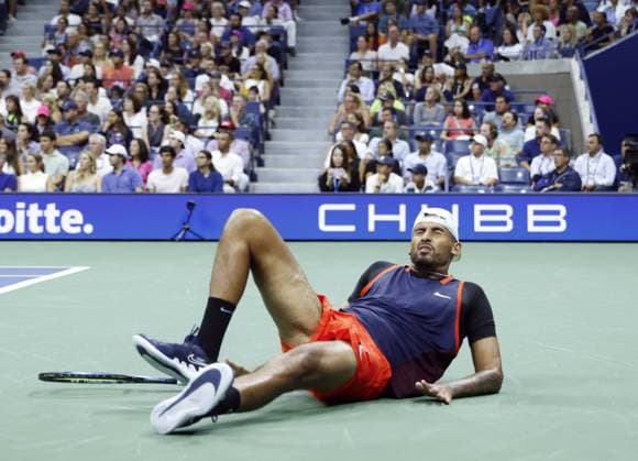Nick Kyrgios of Australia falls down on the court after returning a ball to Daniil Medvedev of Russia in the third set of their fourth round match in Arthur Ashe Stadium at the 2022 US Open Tennis Championships in Arthur Ashe Stadium at the USTA Billie Jean King National Tennis Center in New York City on Sunday, September 4, 2022.  NYP20220904160 JOHNxANGELILLO