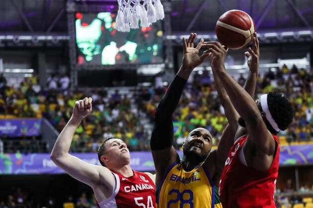 (220911) -- RECIFE, Sept. 11, 2022 -- Thomas Kennedy (L) of Canada and Lucas Mariano (C) of Brazil competes during a semifinal match between Brazil and Canada at the FIBA Americup 2022 in Recife, Brazil, Sept. 10, 2022. ) (SP)BRAZIL-RECIFE-BASKETBALL-FIBA AMERICUP-BRAZIL VS CANADA WangxTiancong 