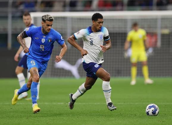Milan, Italy, 23rd September 2022. Jude Bellingham of England surges clear of Gianluca Scamacca of Italy during the UEFA Nations League match at Stadio Giuseppe Meazza, Milan. Picture credit should read: Jonathan Moscrop Sportimage EDITORIAL USE ONLY. No use with unauthorised audio, video, data, fixture lists, club league logos or live services. Online in-match use limited to 120 images, no video emulation. No use in betting, games or single club league player publications. SPI-1892-0022