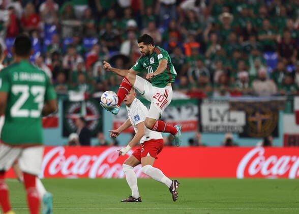22nd November 2022; Stadium 974, Ras Abu Aboud, Doha, Qatar; FIFA World Cup, WM, Weltmeisterschaft, Fussball Football, Mexico versus Poland; Henry Martin of Mexico leaps to pass the ball into midfield  ActionPlus12451848 JohnxPatrickxFletcher