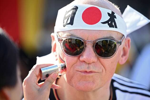 Qatar Soccer World Cup Germany - Japan 8322587 23.11.2022 A Germany s fan is put an image of the German flag on his cheek before the start of the Qatar 2022 World Cup Group E soccer match between Germany and Japan at the Khalifa International Stadium in Doha, Qatar. Grigory Sysoev Sputnik Doha Qatar  Copyright: xGrigoryxSysoevx